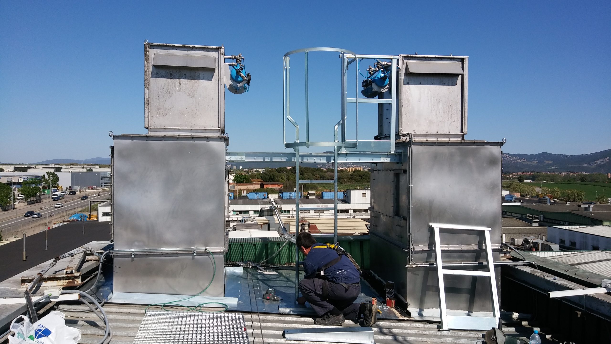 Man Using Measuring Tape in Factory Setting Man Using Measuring Tape in Factory Setting